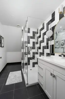 a bathroom with a shower and a sink and a mirror at Kozy Stays Penfield - Modern Rooms Heart of downtown in Montréal