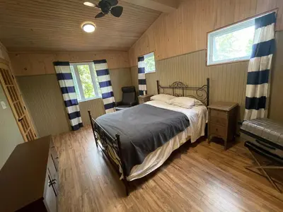 a bedroom with a bed in a room at Beautiful cottage waterfront in Trois-Lacs
