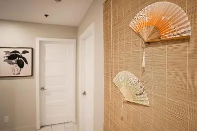 two umbrellas hanging on a wall in a room at 204 - Modern Cozy Suite with 2BR, Gym, Parking, DT & Airport in Montréal