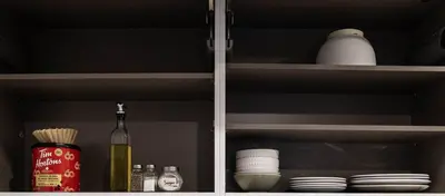 a cabinet with dishes and a bottle of wine and plates at 204 - Modern Cozy Suite with 2BR, Gym, Parking, DT & Airport in Montréal