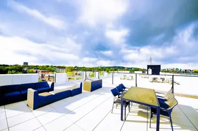 a patio with chairs and a table on a roof at 205 - Cozy Green Oasis 1987 Collection with 2BR,Parking,DT in Montréal