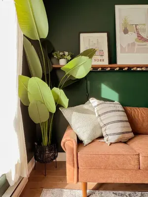 a living room with a couch and a plant at 205 - Cozy Green Oasis 1987 Collection with 2BR,Parking,DT in Montréal