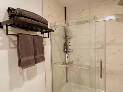 a bathroom with a shower with a glass shower backdoor at 205 - Cozy Green Oasis 1987 Collection with 2BR,Parking,DT in Montréal