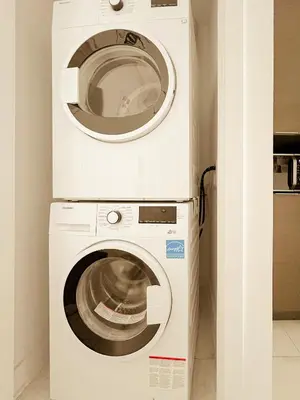 a washing machine and a dryer in a room at 205 - Cozy Green Oasis 1987 Collection with 2BR,Parking,DT in Montréal