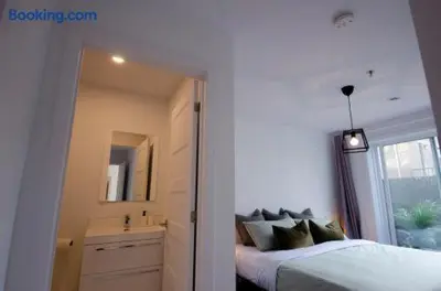 a bedroom with a bed and a sink and a mirror at 103 - Bright Modern 2BR, Near DT W Street Parking in Montréal
