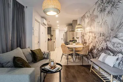 a living room with a couch and a table at 107 - Sleek New 2BR Apt with Patio, Parking, DT&Airport in Montréal