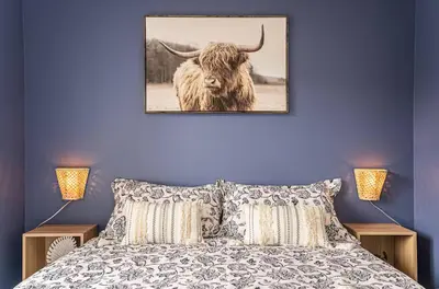 a bedroom with a bed with a picture of a bull at 107 - Sleek New 2BR Apt with Patio, Parking, DT&Airport in Montréal