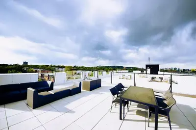 a balcony with couches and a table and chairs at 107 - Sleek New 2BR Apt with Patio, Parking, DT&Airport in Montréal