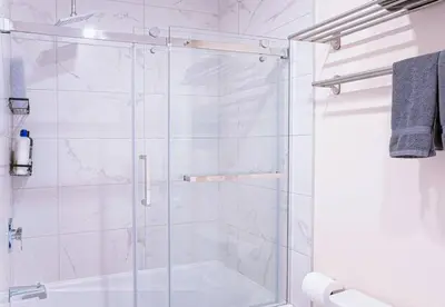 a shower with a glass door in a bathroom at 112 - Spacious 1BR Getaway, Gym, Paid Parking in Montréal