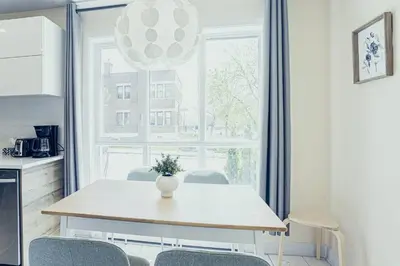 a dining room table with chairs and a vase on it at 112 - Spacious 1BR Getaway, Gym, Paid Parking in Montréal