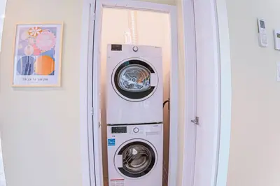 a washing machine and a washer in a room at 112 - Spacious 1BR Getaway, Gym, Paid Parking in Montréal