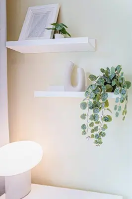 two white shelves with a potted plant on them at 112 - Spacious 1BR Getaway, Gym, Paid Parking in Montréal