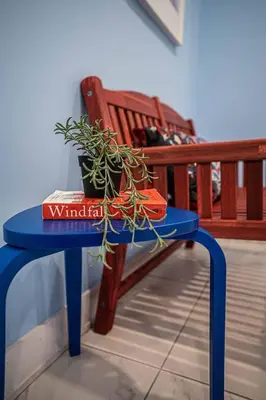 a blue table with a plant on it next to a bench at 117 - Spacious 2 King BD with Parking, Near DT & Airport in Montréal