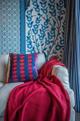 a red blanket sitting on a couch in a room at 117 - Spacious 2 King BD with Parking, Near DT & Airport in Montréal