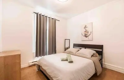 a bedroom with a large bed and a window at FULL KITCHEN 6min from DTOWN Room B in Montréal