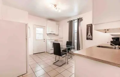 a kitchen with a table and chairs in a room at FULL KITCHEN 6min from DTOWN Room B in Montréal