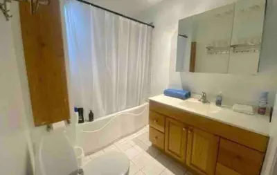 a bathroom with a tub and a sink and a toilet at FULL KITCHEN 6min from DTOWN Room B in Montréal