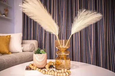 a vase with feathers on a table in a living room at 119 - Vibrant Chic Designer 2BR with Gym,Parking,Airport&DT in Montréal