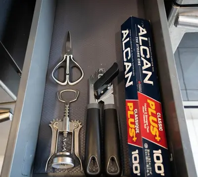 a drawer with a tool kit and a book at 201 - Comfy Spacious 2BR Apt with Gym, Parking, DT&Airport in Montréal