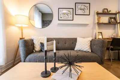 a living room with a couch and a table at 202 - Modern Exquisite Suite with Gym,Parking, near DT&Airport in Montréal