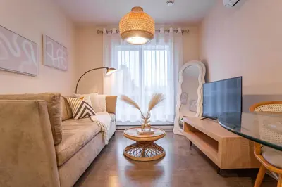 a living room with a couch and a glass table at 203 - Fantastic Cozy New 2 Queen Condo with Gym, DT&Airport in Montréal