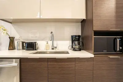 a kitchen with a sink and a microwave at 207 - Mondern Cozy New Apt with 2BR, Prking, Gym,DT&Airport in Montréal