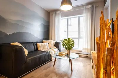a living room with a couch and a table at 207 - Mondern Cozy New Apt with 2BR, Prking, Gym,DT&Airport in Montréal