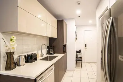 a kitchen with a sink and a counter top at 207 - Mondern Cozy New Apt with 2BR, Prking, Gym,DT&Airport in Montréal