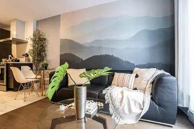 a living room with a couch and a mountain mural at 207 - Mondern Cozy New Apt with 2BR, Prking, Gym,DT&Airport in Montréal