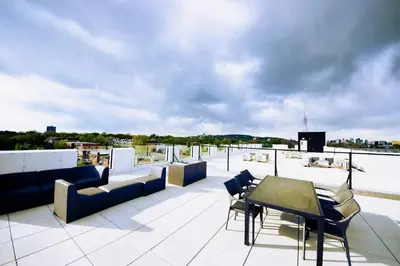 a patio with chairs and tables on a roof at 207 - Mondern Cozy New Apt with 2BR, Prking, Gym,DT&Airport in Montréal