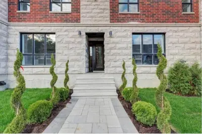 a brick house with a walkway in front of it at 208 - Modern Cozy Bright Apt with 2BR,Gym,Prking,DT&Airport in Montréal