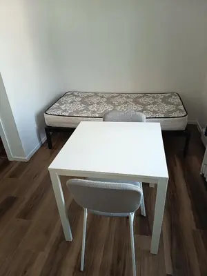 a room with a desk and a table and a bed at Iphigenie in Montréal