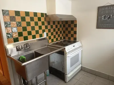 a kitchen with a sink and a stove at Iphigenie in Montréal