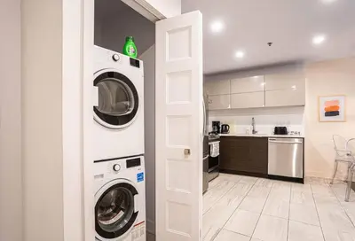 a kitchen with two washing machines in a room at 210 - Fantastic Neat 2BR with Parking, Gym, near DT&Airport in Montréal