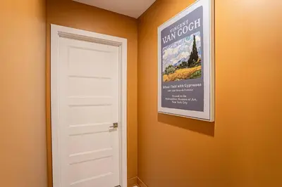 a door in a room with a poster on the wall at 211 - Cozy New Condo with 2 Queens, Parking, DT&Airport in Montréal
