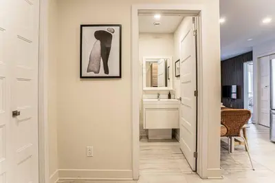 a hallway with a door leading to a bathroom at 214 - Boho Ambiance Designer 2BR with Gym,Prking,DT&Airport in Montréal