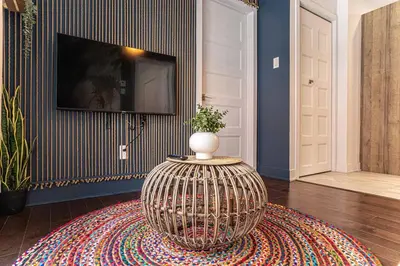 a living room with a television and a vase on a table at 214 - Boho Ambiance Designer 2BR with Gym,Prking,DT&Airport in Montréal