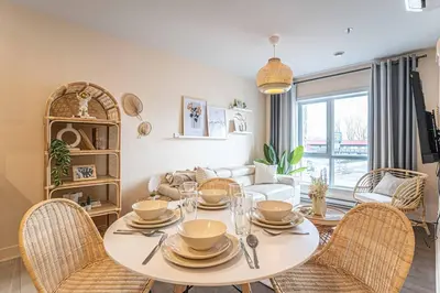 a dining room with a white table and chairs at 217 - Pastel Stylist 2 KING-BR with Parking, nr DT&Airport in Montréal