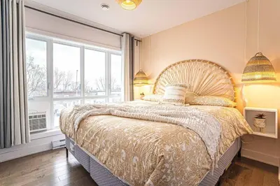 a bedroom with a large bed with a large window at 217 - Pastel Stylist 2 KING-BR with Parking, nr DT&Airport in Montréal