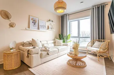 a living room with a couch and a large window at 217 - Pastel Stylist 2 KING-BR with Parking, nr DT&Airport in Montréal