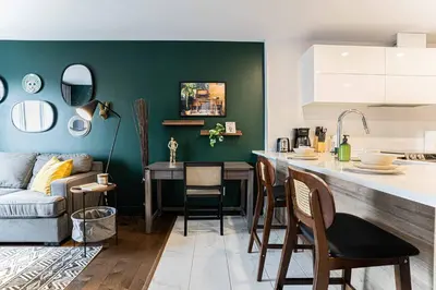 a kitchen and living room with a couch and a table at 218 - Emerald Retro KING Suite with Parking, Gym,DT&Airport in Montréal