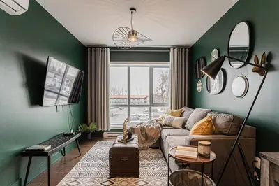 a living room with green walls and a couch at 218 - Emerald Retro KING Suite with Parking, Gym,DT&Airport in Montréal