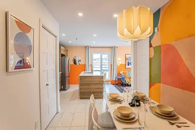 a kitchen and dining room with a table and chairs at 219 - Abstract Designer King Suite with Parking, DT&Airport in Montréal