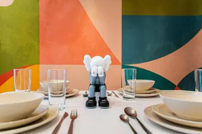 a table with plates and utensils and a figurine on top of it at 219 - Abstract Designer King Suite with Parking, DT&Airport in Montréal
