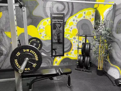 a gym with a chair and a wall with graffiti at 219 - Abstract Designer King Suite with Parking, DT&Airport in Montréal