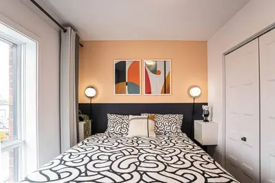 a bedroom with a bed and a large window at 219 - Abstract Designer King Suite with Parking, DT&Airport in Montréal