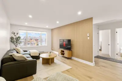 a living room with a couch and a tv at The Samson Haven in Laval