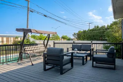 a deck with chairs and a table and an umbrella at Residence Havre d'abraham in Laval