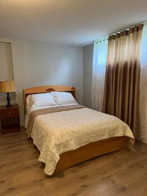 a bedroom with a bed and a window with a curtain at Residence Havre d'abraham in Laval