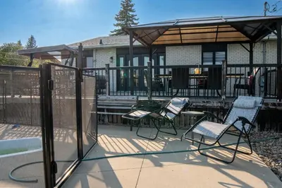 a group of chairs on a patio in front of a house at Residence Havre d'abraham in Laval